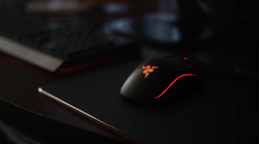One of the best mouse for rainbow six siege - the Razer DeathAdder, placed on a mousepad.