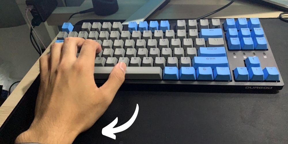 A picture of a my hand in a straight position on a straight-lined keyboard.